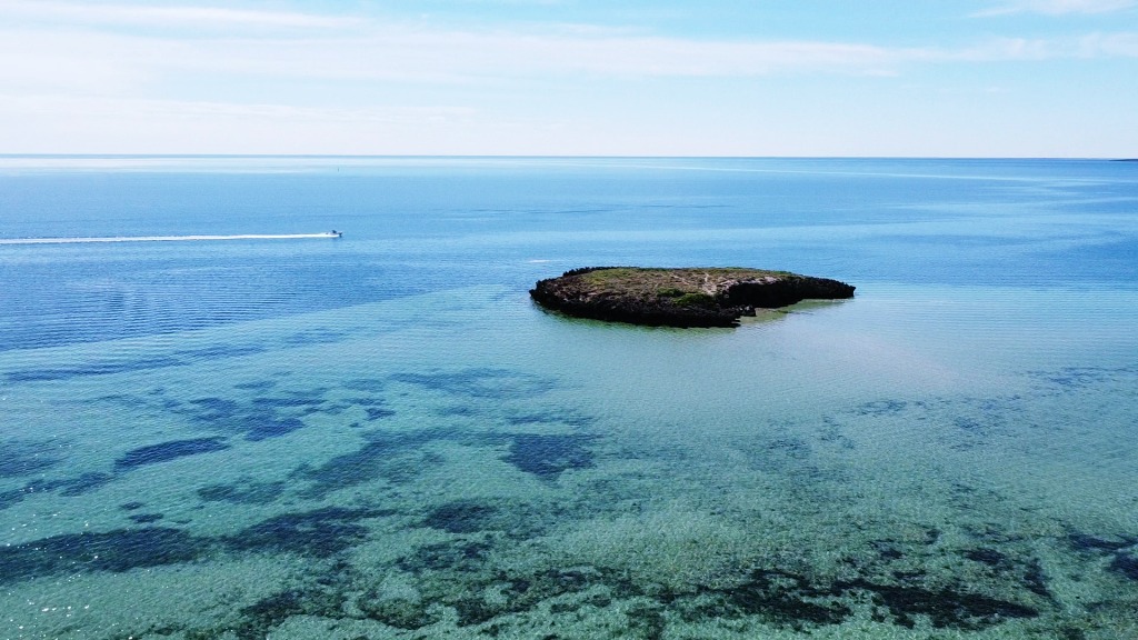 Little Islands and a tinny heading out to fish