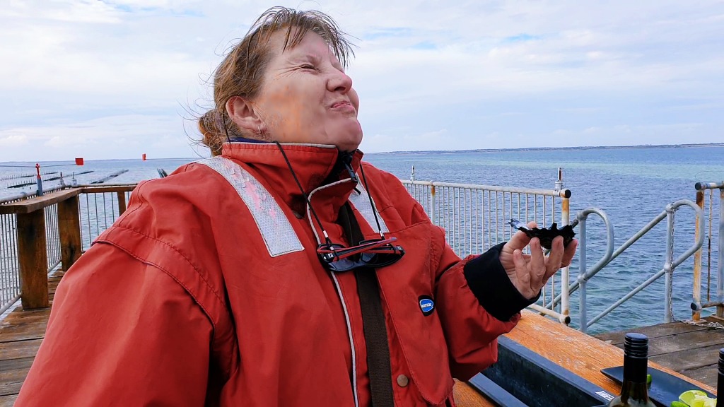 Miss Linda trying fresh oysters for the first time