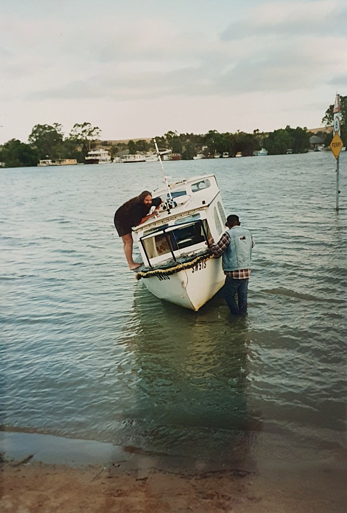 Fred checking out the hole in Huck's hull