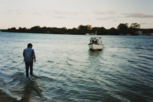 Fred aiding his old boat, Huck Finn